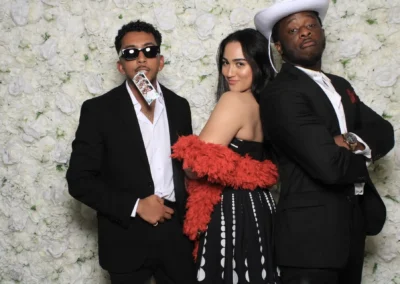 two men and a woman posing for beauty and vintage booth tesoro moments